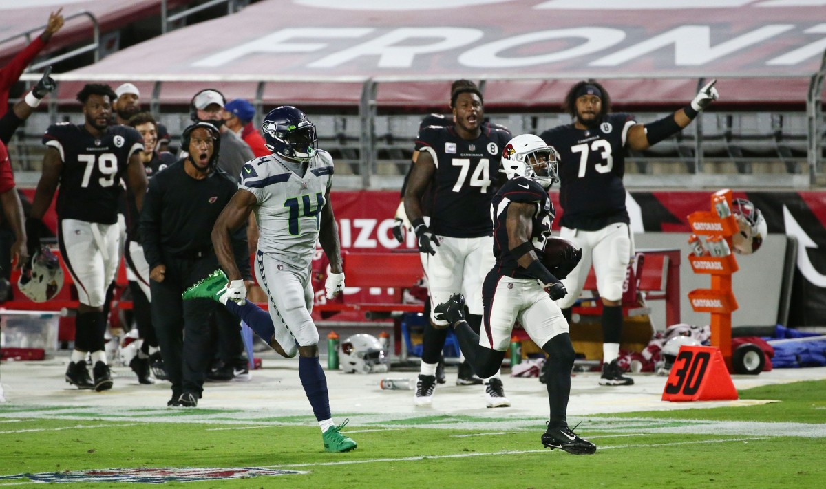 Arizona Cardinals strong safety Budda Baker (32) intercepts a pass and is tackled short of the goal line by Seattle Seahawks wide receiver DK Metcalf (14) in the first half during a game at State Farm Stadium. Mandatory Credit: Rob Schumacher/The Arizona Republic via USA TODAY NETWORK Nfl Seattle Seahawks At Arizona Cardinals